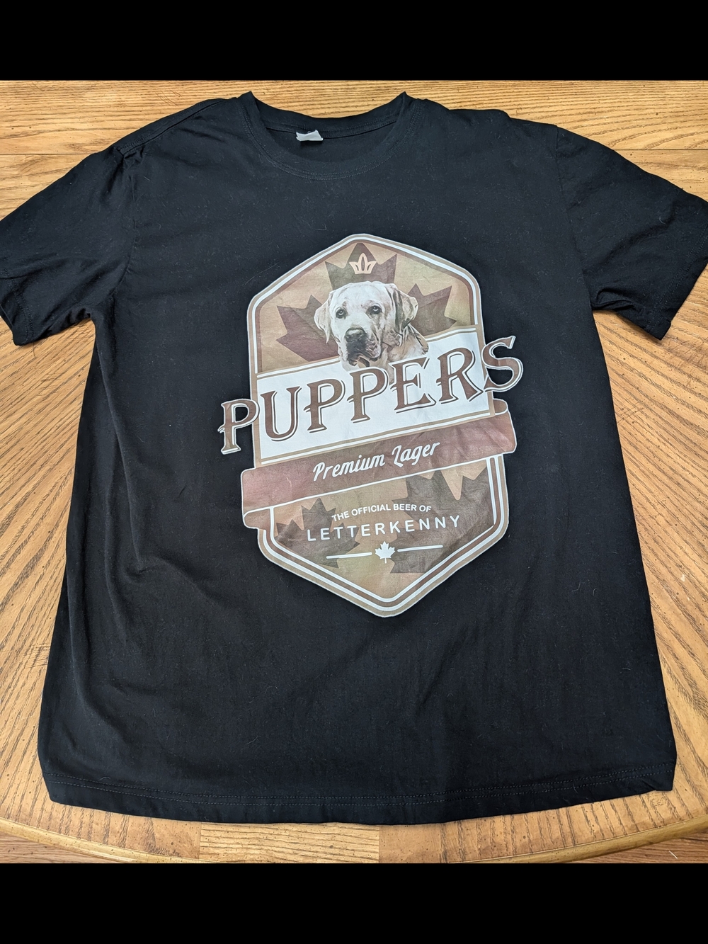 Puppers Premium Lager Black Graphic Tee. Letterkenny